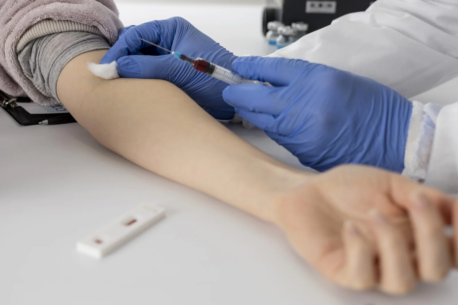 close-up-doctor-taking-blood-sample-from-patient-scaled