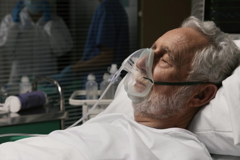 old-man-with-respirator-hospital-bed